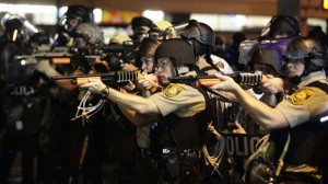 Police-officers-point-their-weapons-at-demonstrators-protesting-against-the-shooting-death-of-Michael-Brown-in-Ferguson-Missouri-August-18-2014.-REUTERS_Joshua-Lott1